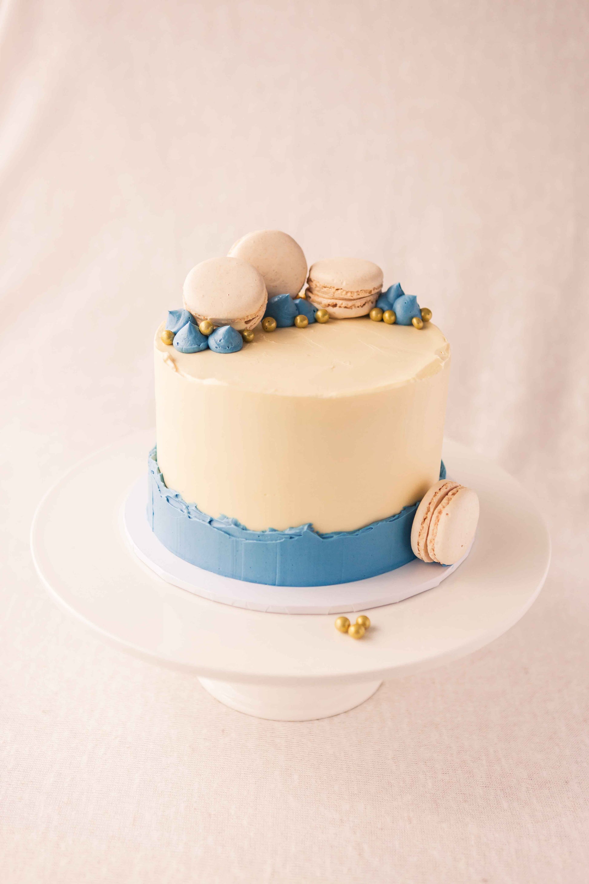 cute little white and blue cake with macarons