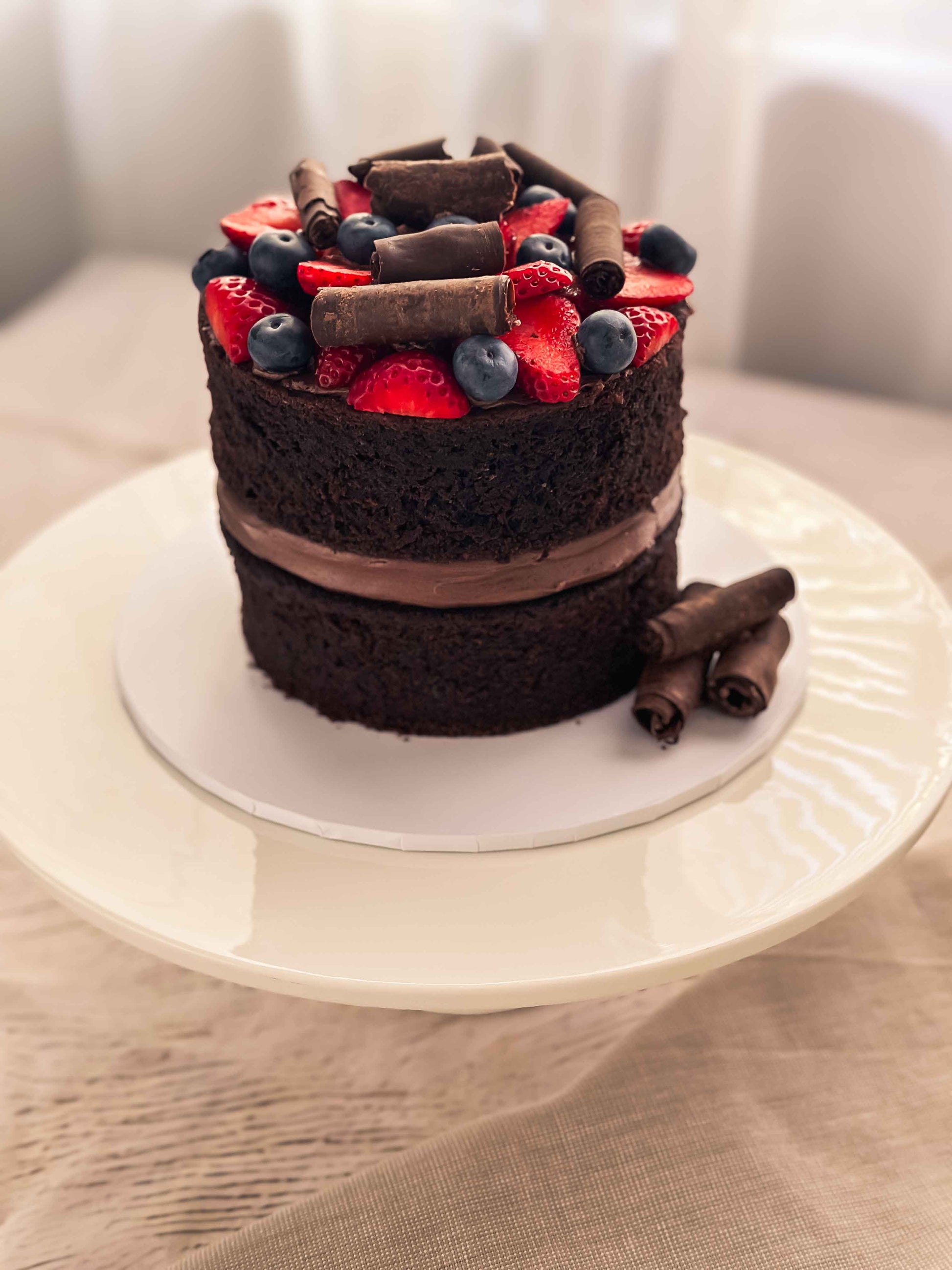Handmade chocolate naked cake with strawberries and blueberries, baked in Perth.