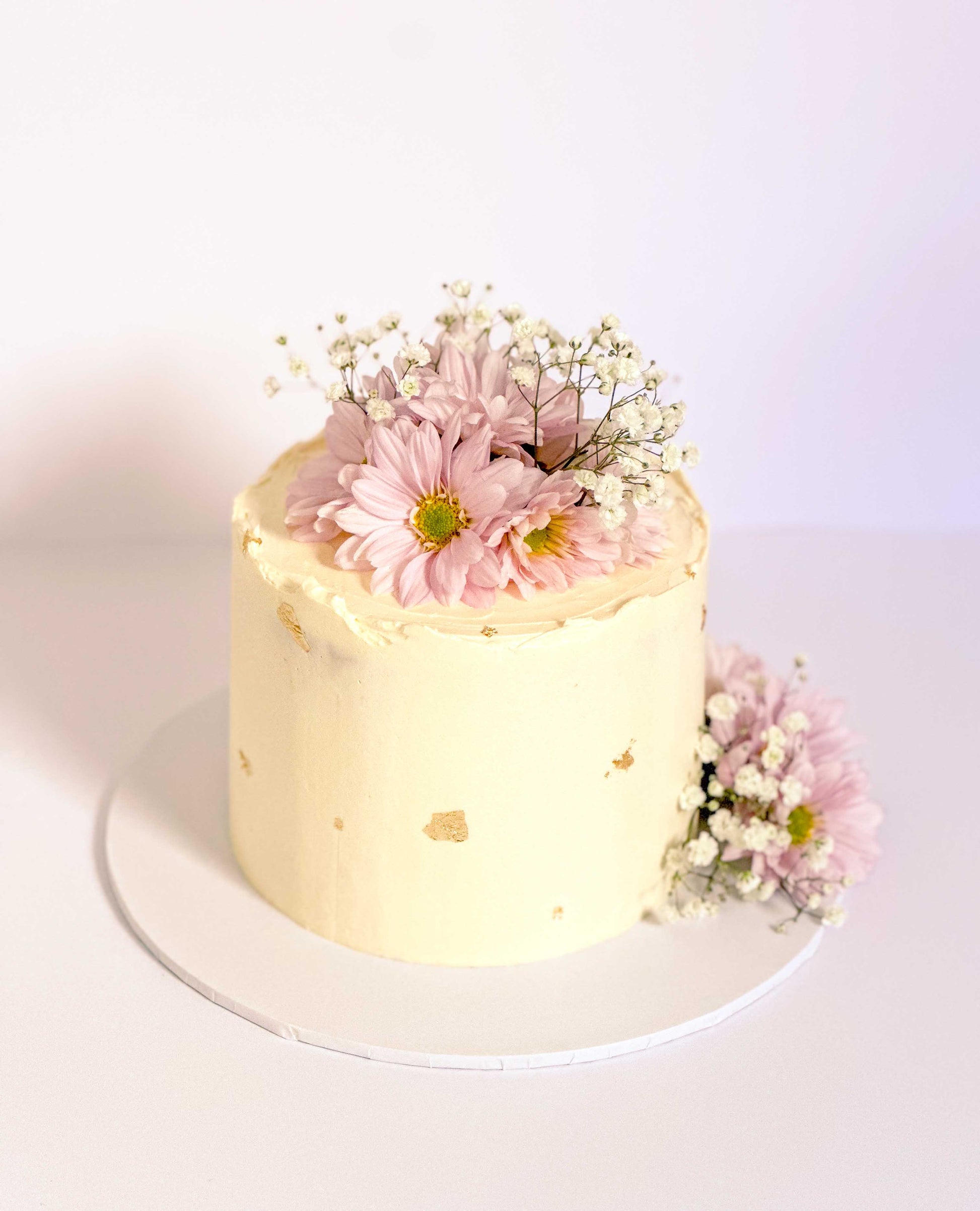 small cake with flowers and gold touches