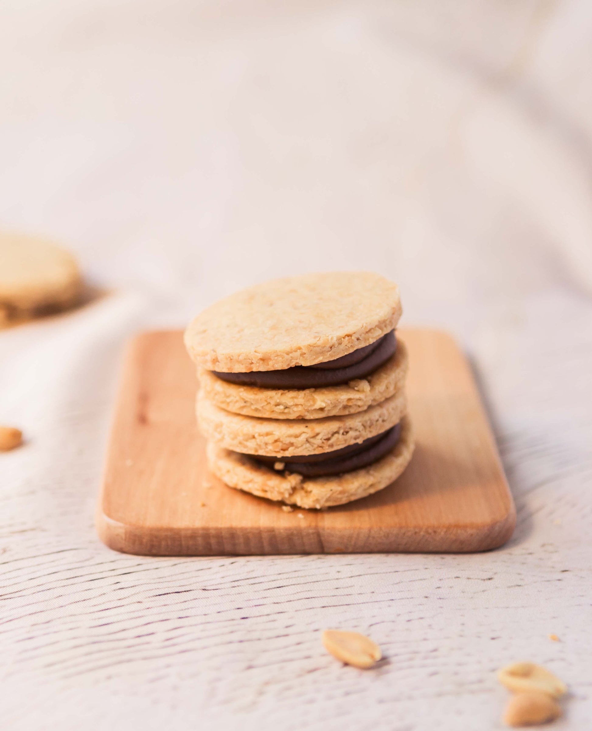 Artisan peanut alfajores with a ring of dulce de leche and a creamy peanut butter centre.