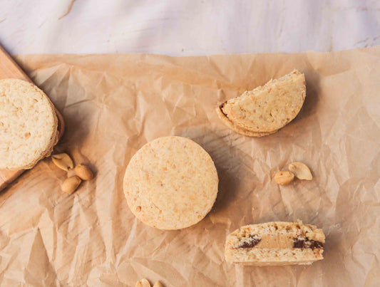 Freshly baked peanut alfajores filled with dulce de leche and peanut butter